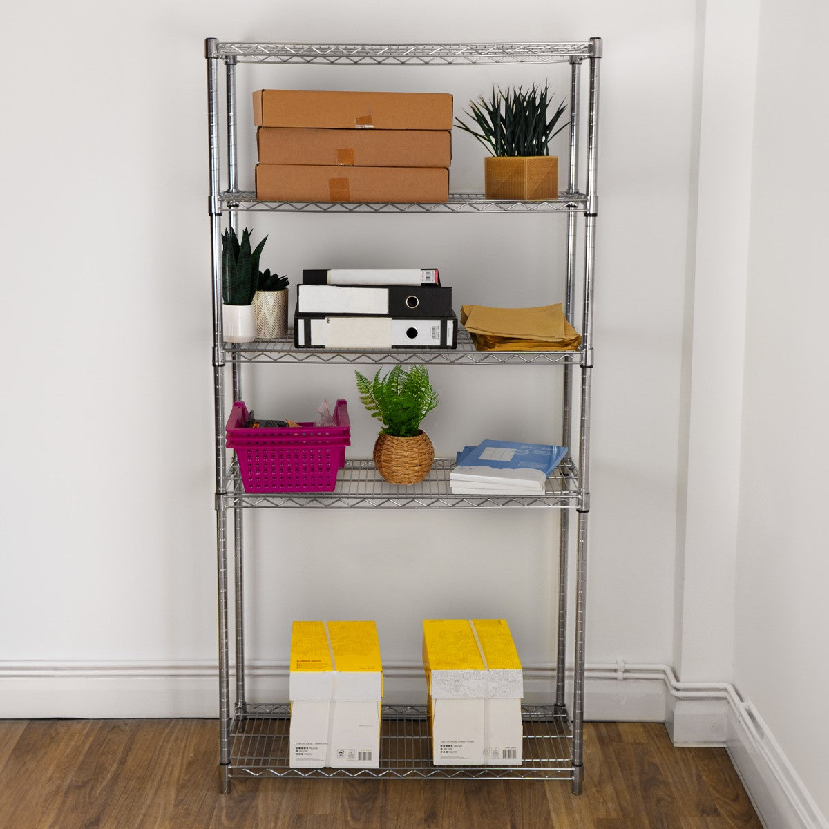 Metal wire racking unit with five shelves, featuring boxes, plants, and storage bins in a bright, organized space