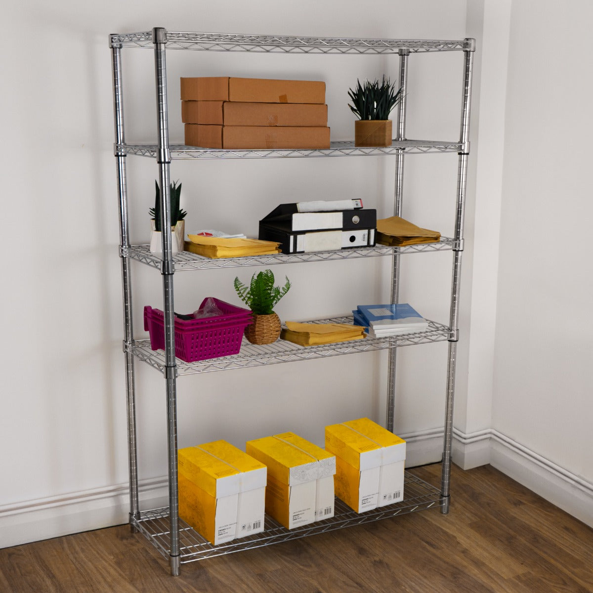 Sturdy silver wire racking unit with five shelves, displaying boxes, plants, and colorful storage bins in a bright room