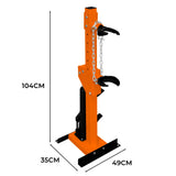 Hydraulic coil spring strut in bright orange with black base, featuring two hooks and a sturdy design for lifting and support