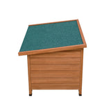 Small wooden dog kennel with a slanted green roof, featuring a natural wood finish and textured siding for durability
