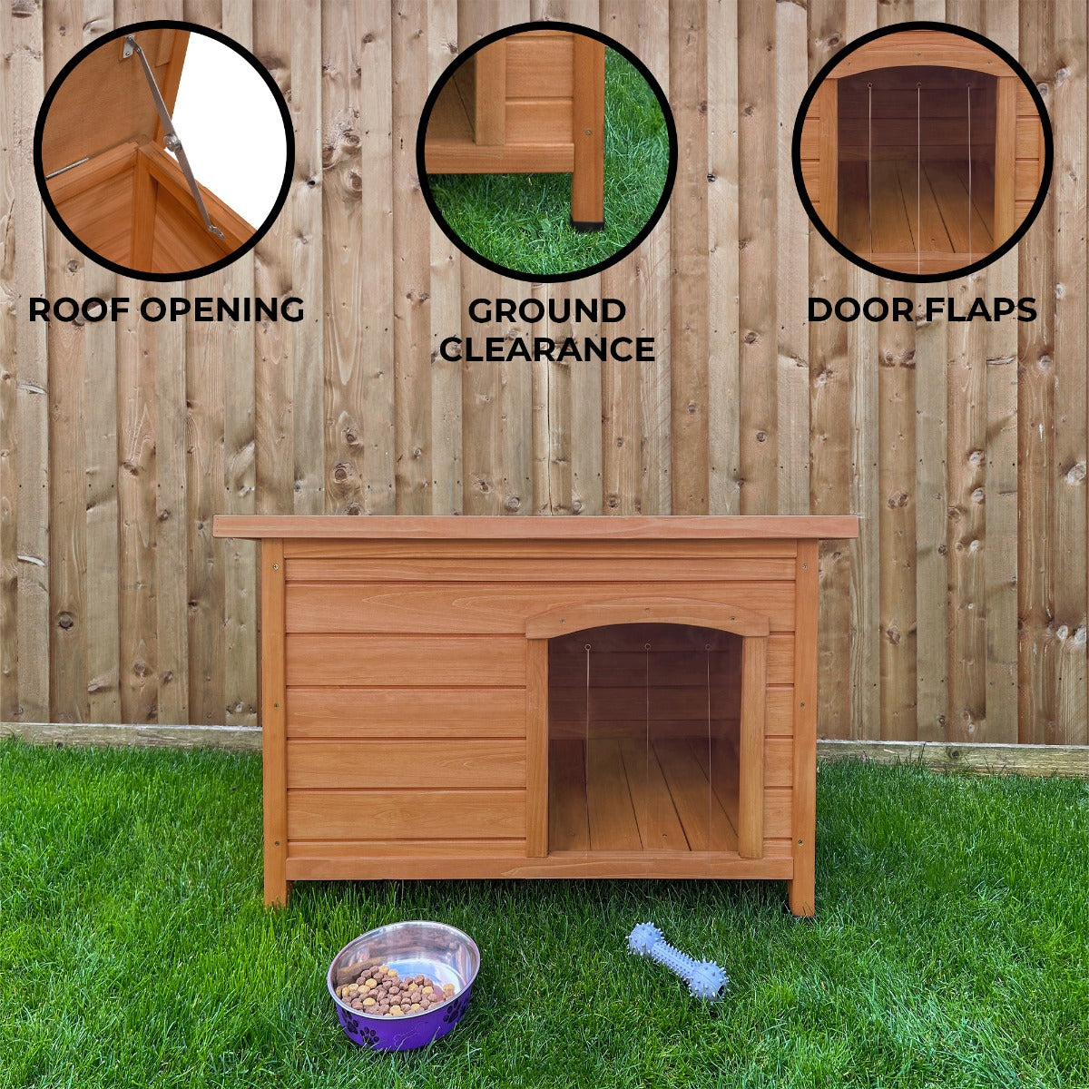Small wooden dog kennel with a slanted roof, ground clearance, and door flaps, set on grass against a wooden fence