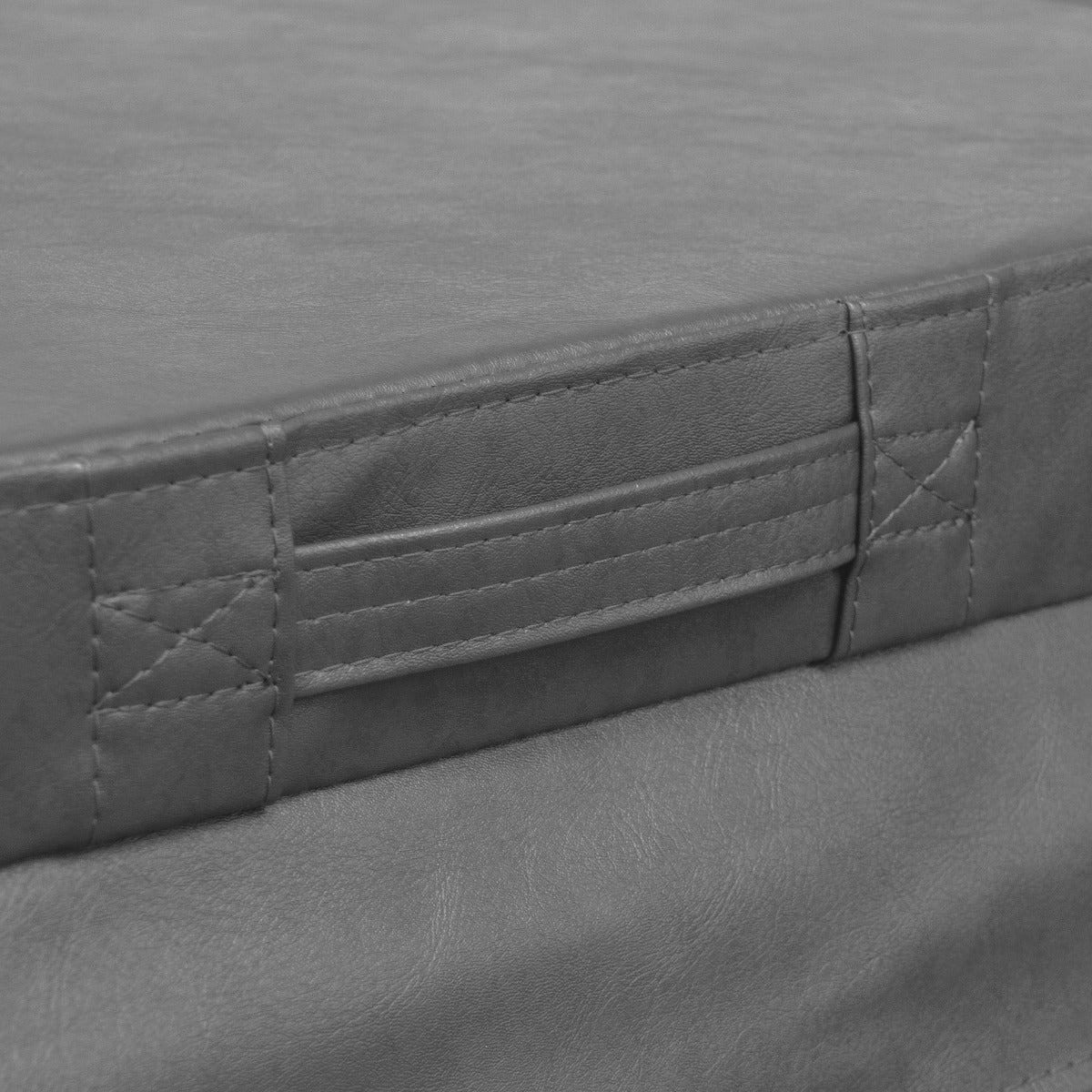 Grey hot tub spa cover with a textured surface, featuring sturdy stitching and convenient handles for easy lifting and securing