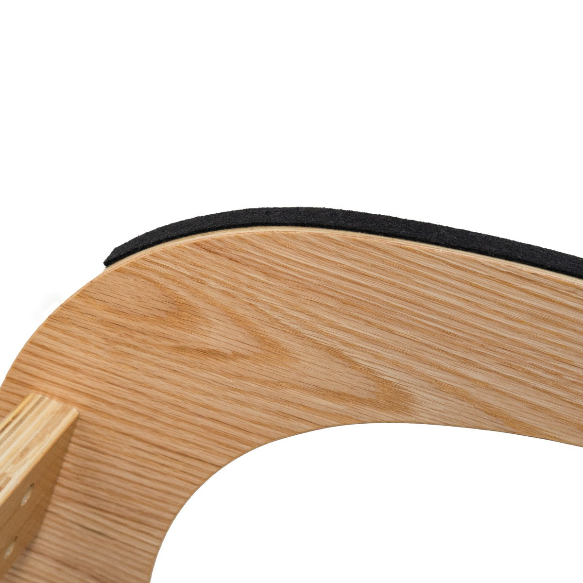 Curved wooden frame of an ergonomic kneeling chair with a soft black cushion, showcasing natural wood grain and smooth texture