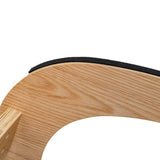 Curved wooden frame of an ergonomic kneeling chair with a soft black cushion, showcasing natural wood grain and smooth texture