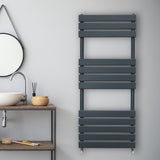 Sleek anthracite grey flat panel towel radiator mounted on a wall, featuring horizontal slats and a modern design in a stylish bathroom setting
