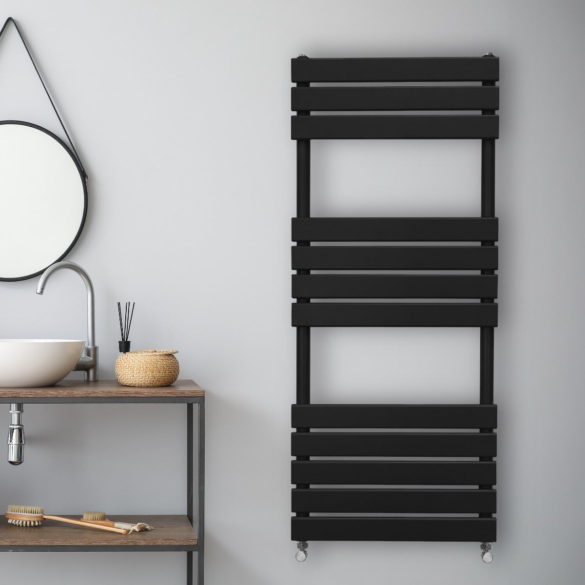 Sleek black flat panel towel radiator mounted on a wall, featuring horizontal slats and a modern design, ideal for stylish bathrooms