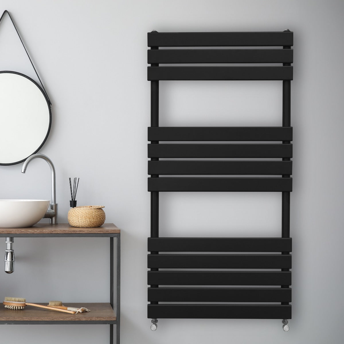 Sleek black flat panel towel radiator with horizontal slats, mounted on a light gray wall, enhancing modern bathroom decor