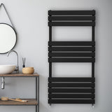Sleek black flat panel towel radiator with horizontal slats, mounted on a light gray wall, enhancing modern bathroom decor