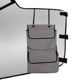 Reflective motorhome screen cover with a gray storage pocket, featuring black trim and adjustable straps for secure fit