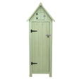 Tall wooden garden shed in a soft green color, featuring a pointed roof, vertical slats, and a small upper storage compartment