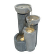 Three-tiered electric water feature in textured gray stone, with water cascading gently between bowls, creating a serene ambiance