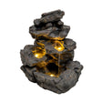 Rustic electric water feature with cascading waterfalls, textured dark stone, and warm glowing lights creating a serene ambiance