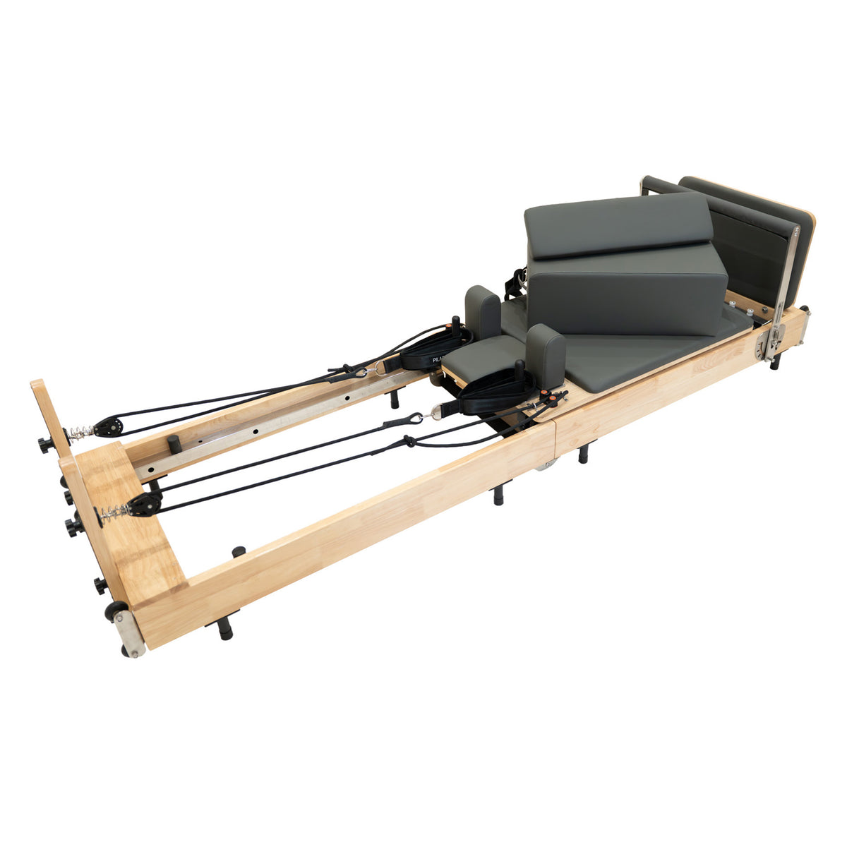 Wooden Pilates reformer with gray padded cushions, adjustable springs, and a sleek, modern design for effective workouts