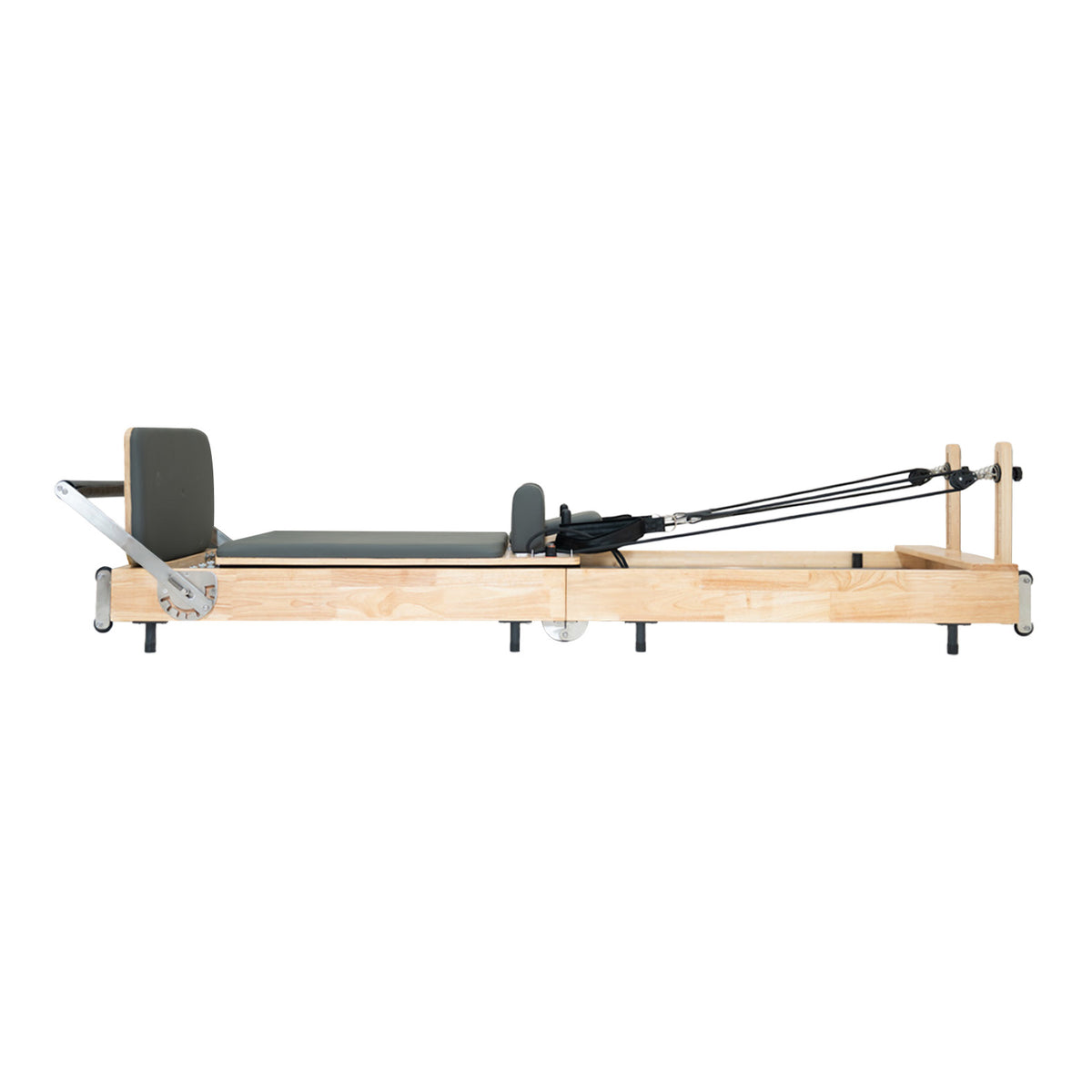 Wooden Pilates reformer with a sleek gray padded surface, featuring adjustable straps and a minimalist design for effective workouts