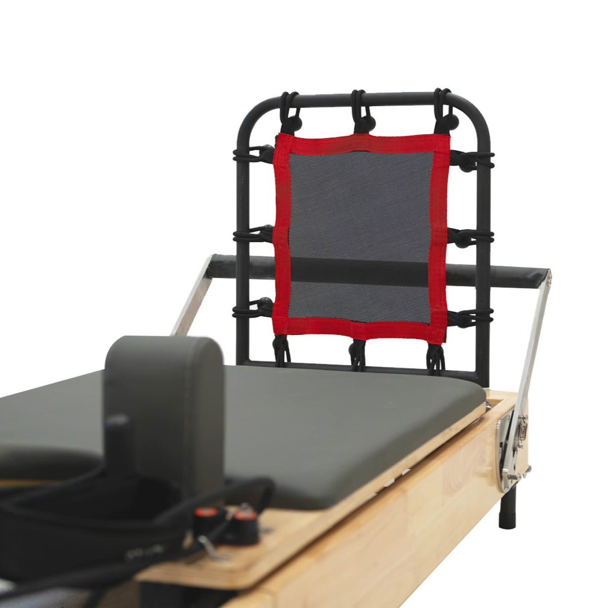 Reformer Pilates machine featuring a black frame, gray padded surface, and a red-trimmed mesh backrest for enhanced support