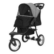 Stylish grey pet jogger with a spacious black compartment, sturdy wheels, and a protective canopy for comfortable outings