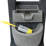 Gray electric water feature with a textured finish, featuring a built-in basin and a yellow cleaning brush resting inside