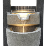 Stylish electric water feature with cascading water, textured gray stone finish, and soft ambient lighting for a serene atmosphere