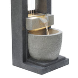 Sleek electric water feature with cascading water over textured stone, featuring a modern gray design and illuminated basin