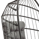 Black rattan hanging egg chair featuring a cushioned seat with tufted gray fabric, showcasing a modern and stylish design