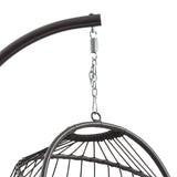 Black rattan hanging egg chair with a curved metal frame, featuring a woven texture and a sleek, modern design for outdoor relaxation