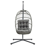 Stylish grey rattan hanging egg chair with plush cushion, featuring a sturdy metal stand and a modern, airy design for relaxation