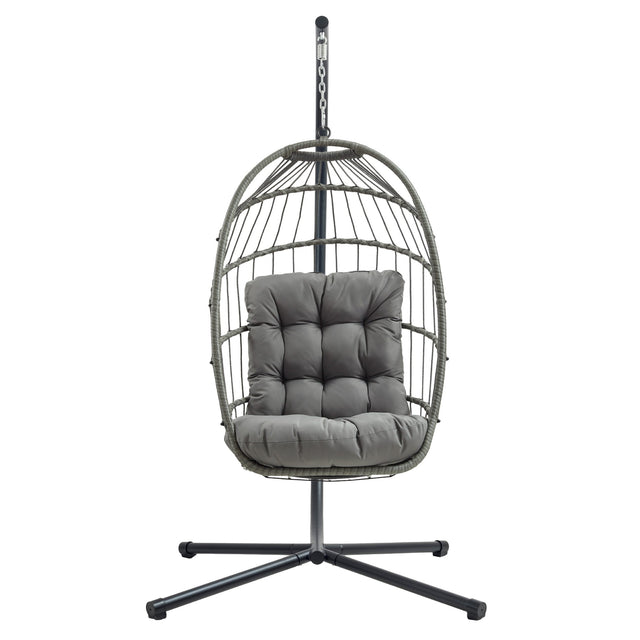 Stylish grey rattan hanging egg chair with plush cushion, featuring a sturdy metal stand and a modern, airy design for relaxation