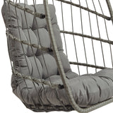 Stylish grey rattan hanging egg chair featuring a plush, tufted cushion and a woven frame, perfect for indoor or outdoor relaxation