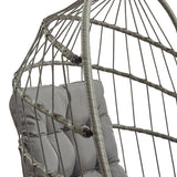 Stylish grey rattan hanging egg chair featuring a cozy cushion, intricate woven design, and a sturdy metal frame for outdoor relaxation