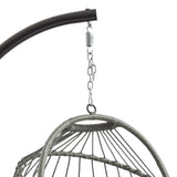 Grey rattan hanging egg chair suspended from a sleek metal frame, featuring a woven texture and curved shape for cozy seating
