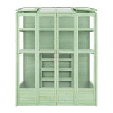 Victorian-style greenhouse in a soft green hue, featuring wooden panels, glass roof, and multiple shelves for plants and gardening tools