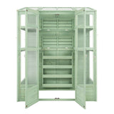 Victorian greenhouse in soft green, featuring wooden shelves, glass panels, and double doors for easy access and ventilation