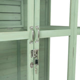 Victorian greenhouse in soft green, featuring wooden panels, metal handles, and a secure lock for stylish plant storage