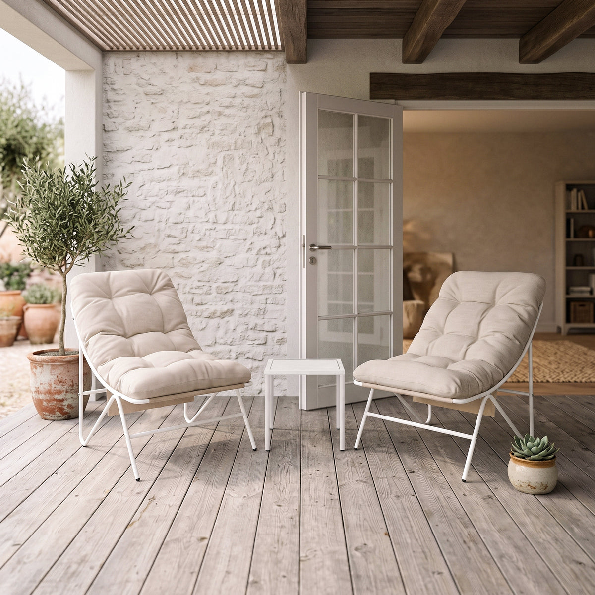 Cream-colored cushions on two modern bistro chairs with a white metal frame, accompanied by a small glass table, set on a wooden patio
