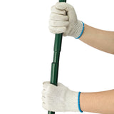 Hands in gray gloves gripping a green 100cm lawn leveller, showcasing its sturdy design and ergonomic handle for easy use