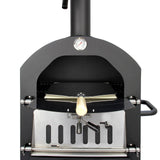 Black KuKoo outdoor pizza oven with a stainless steel front, a wooden pizza peel, and a built-in thermometer for precise cooking