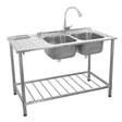 Stainless steel double bowl catering sink with left-hand drainer, featuring a high-arc faucet and sturdy open shelf below