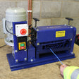T-Mech Automatic Wire Stripper in blue with a motor, featuring control buttons and a warning label, designed for efficient wire stripping