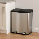 Sleek 60L dual pedal bin in stainless steel with a black lid, positioned beside a kitchen cabinet on a wooden floor