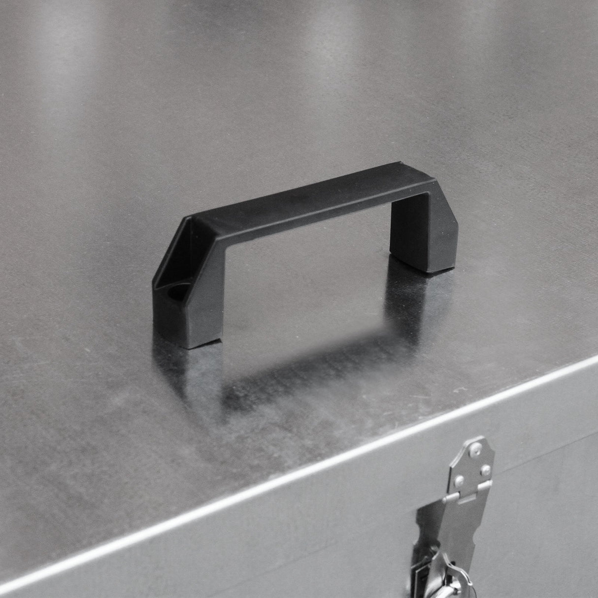 Galvanised feed store compartment featuring a sturdy black handle, sleek metallic surface, and secure latch for easy access