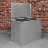 Galvanised metal feed store with two compartments, featuring a smooth, shiny surface and a hinged lid against a brick background