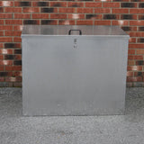 Galvanised steel feed store with three compartments, featuring a secure lid, sturdy handle, and a sleek metallic finish against a brick background