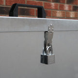 Galvanised feed store with three compartments, featuring a sturdy metal latch and a padlock for secure storage, against a brick background