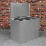 Galvanised steel feed store with three compartments, featuring a sturdy design and a smooth, shiny surface against a brick background