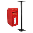 Bright red Royal Mail post box with a gold crown emblem, featuring a slot for letters and a sturdy black metal stand