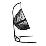 Black hanging rattan egg chair with a curved design, featuring a sturdy metal frame and woven texture for a modern look