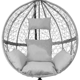 Grey hanging rattan egg chair featuring a round woven design, plush cushions, and a sturdy stand for stylish indoor or outdoor seating