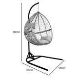 Grey hanging rattan egg chair with plush cushions, featuring a sturdy black metal frame and intricate woven design, perfect for outdoor relaxation