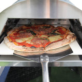 Freshly baked pizza with pepperoni and basil, resting on a stone inside a sleek outdoor pizza oven with stainless steel finish
