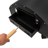 Black outdoor pizza oven with a wooden handle, showcasing a pull-out tray for easy access to the cooking area and ventilation holes